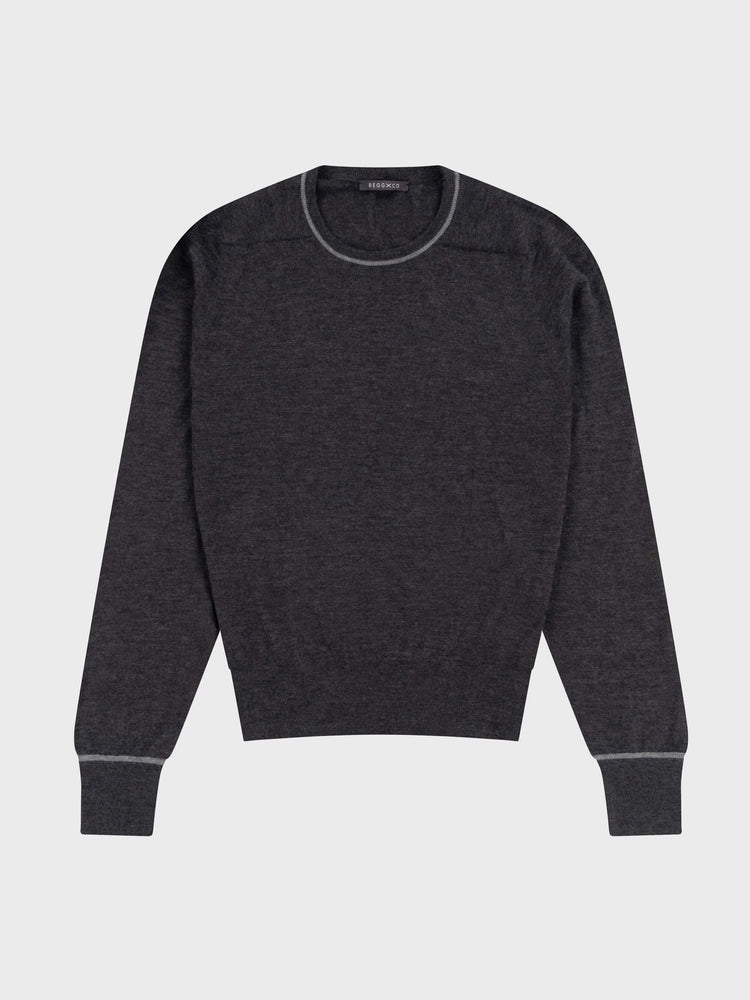 mens dark grey cashmere crewneck sweater with light grey piping details on a grey background