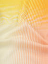 close up of a orange and yellow square cashmere scarf with a gradient check design
