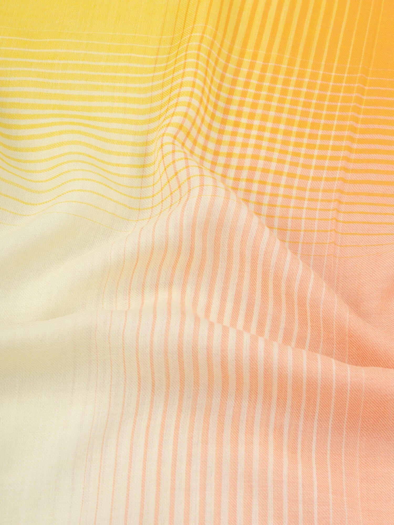close up of a orange and yellow square cashmere scarf with a gradient check design
