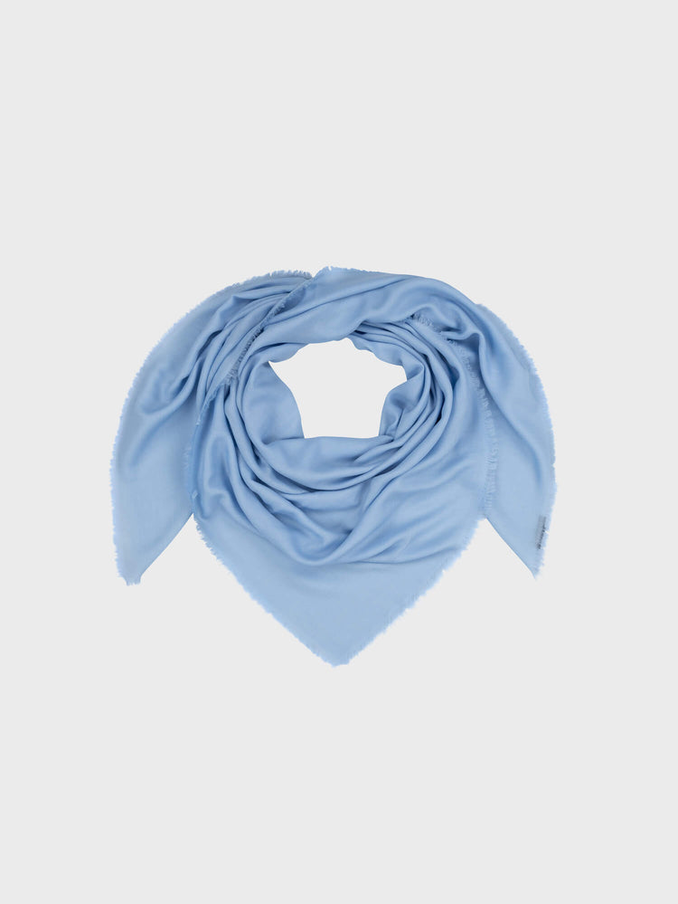 lightweight blue square cashmere scarf on a grey background