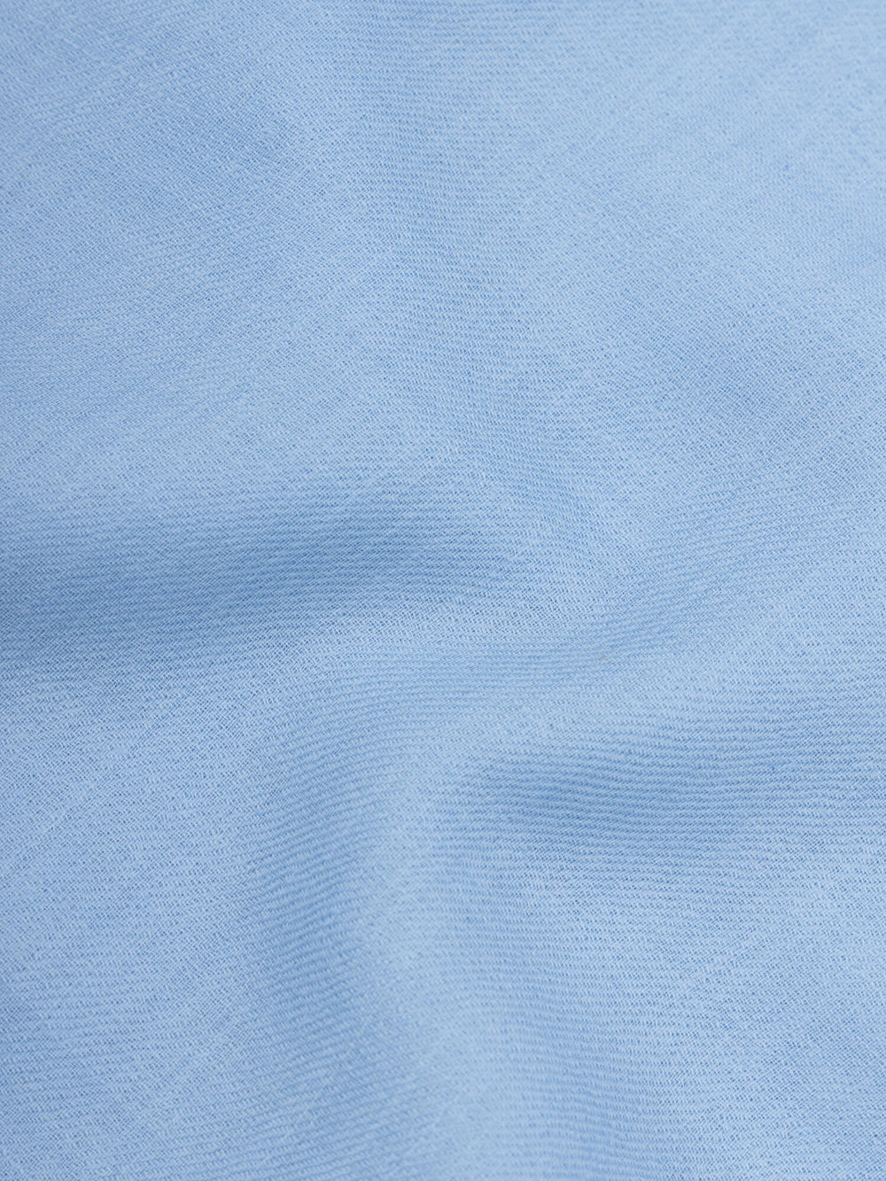 close up of a lightweight blue square cashmere scarf