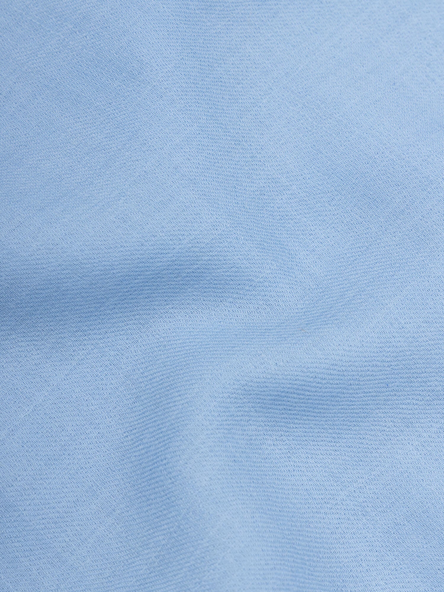 close up of a lightweight blue square cashmere scarf