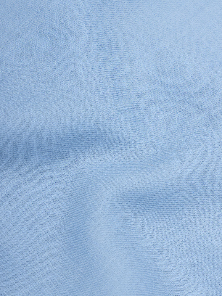 close up of a lightweight blue square cashmere scarf