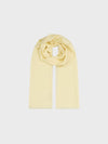 light yellow lightweight cashmere scarf on a grey background
