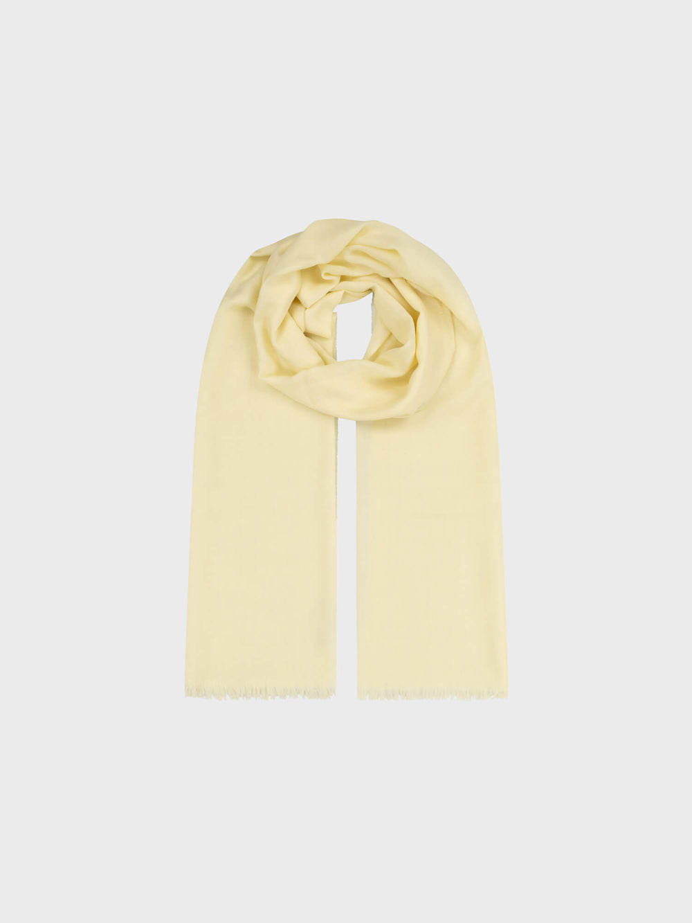 light yellow lightweight cashmere scarf on a grey background