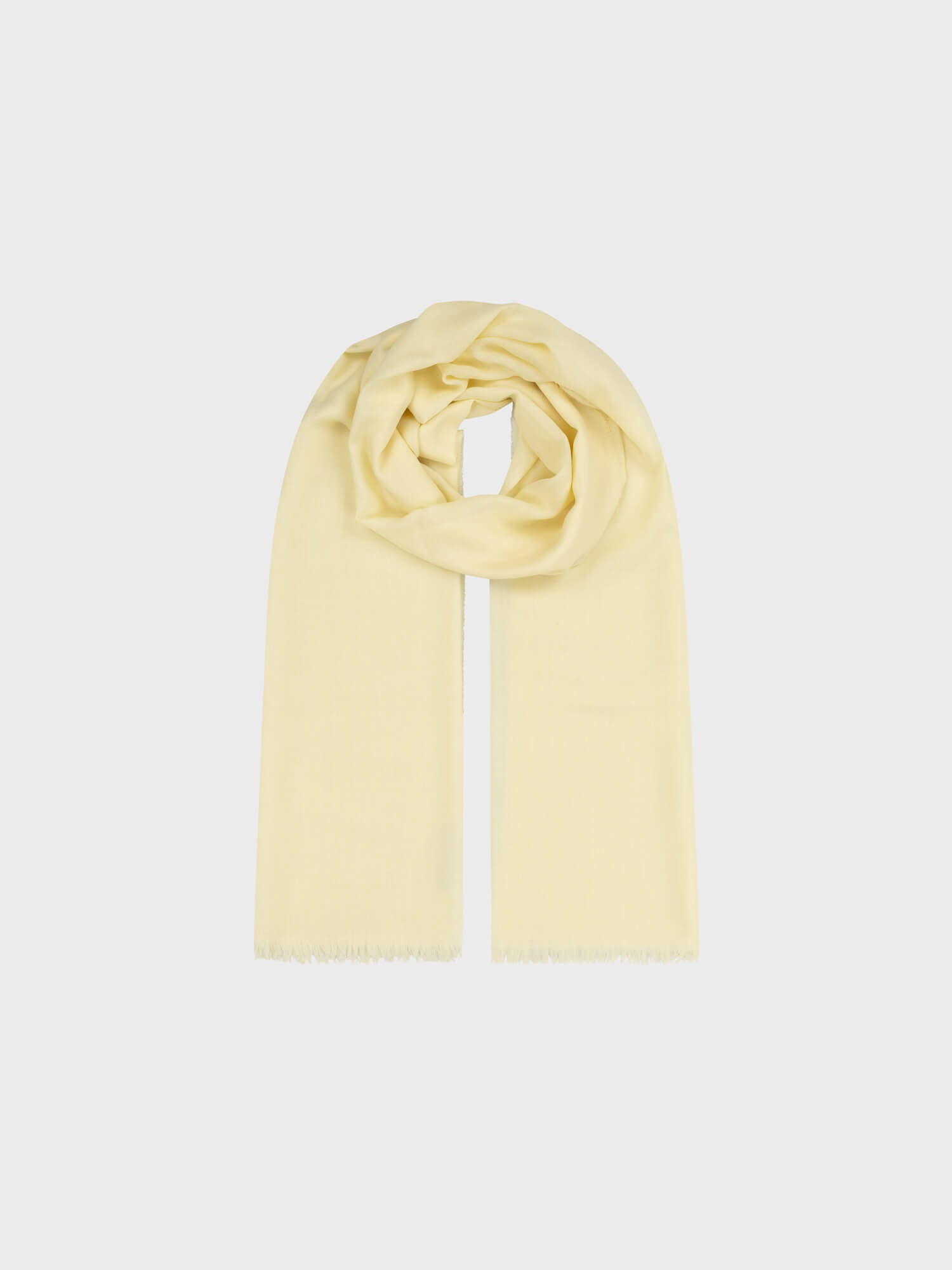 light yellow lightweight cashmere scarf on a grey background