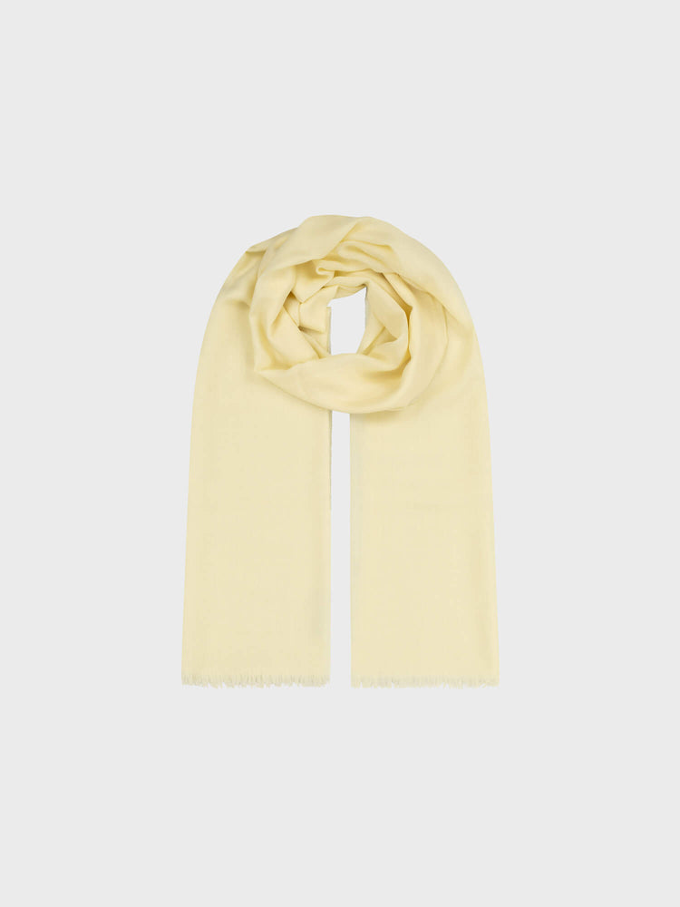 light yellow lightweight cashmere scarf on a grey background