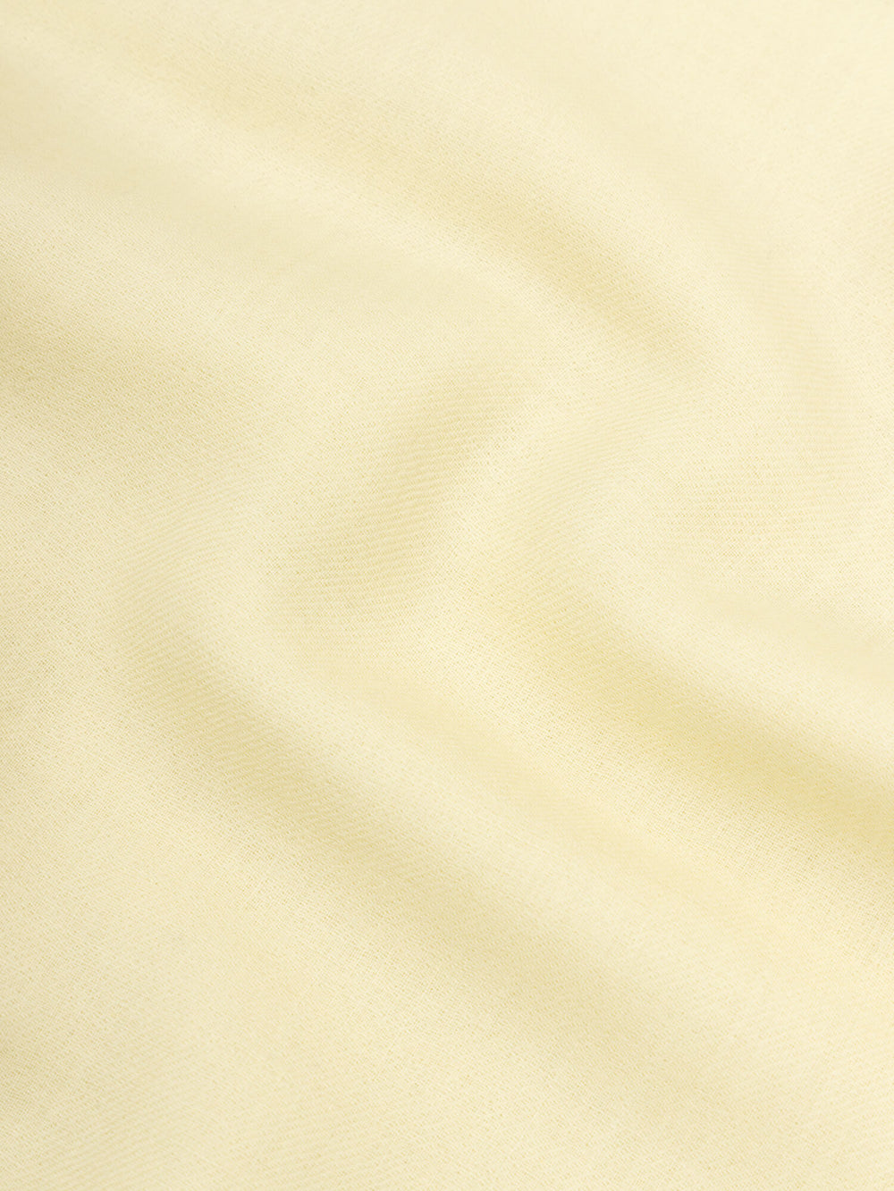close up of a light yellow lightweight cashmere scarf