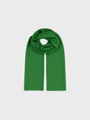 lightweight green cashmere scarf on a grey background