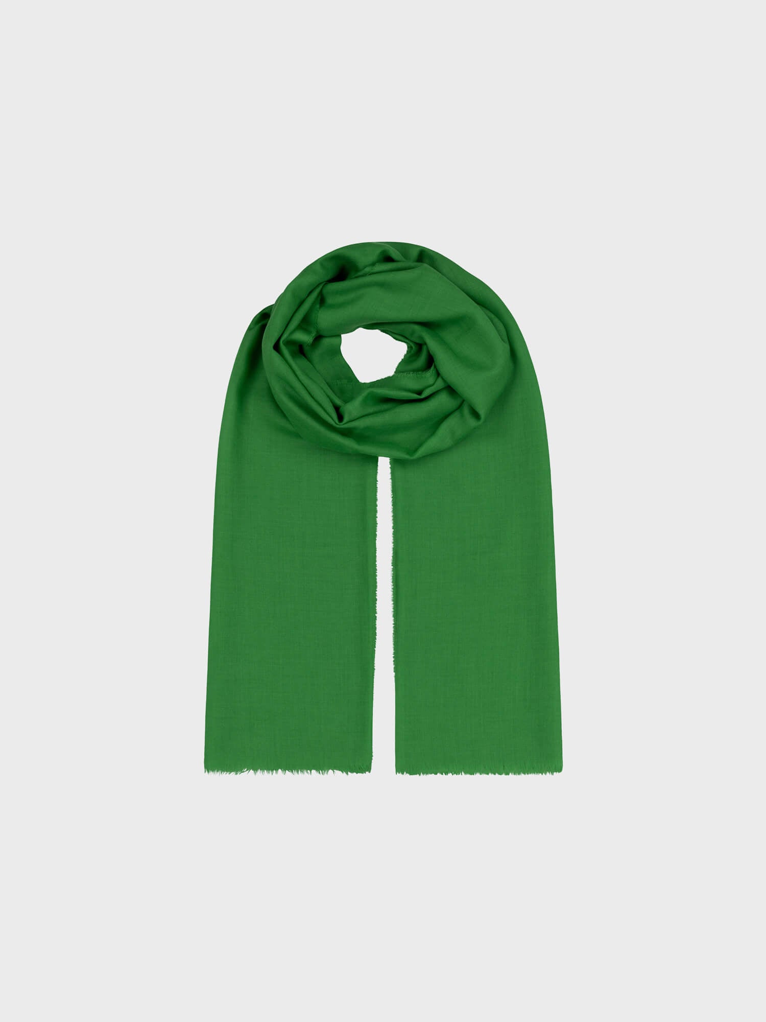 lightweight green cashmere scarf on a grey background