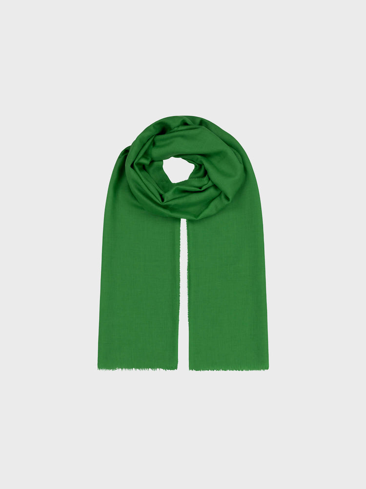 lightweight green cashmere scarf on a grey background