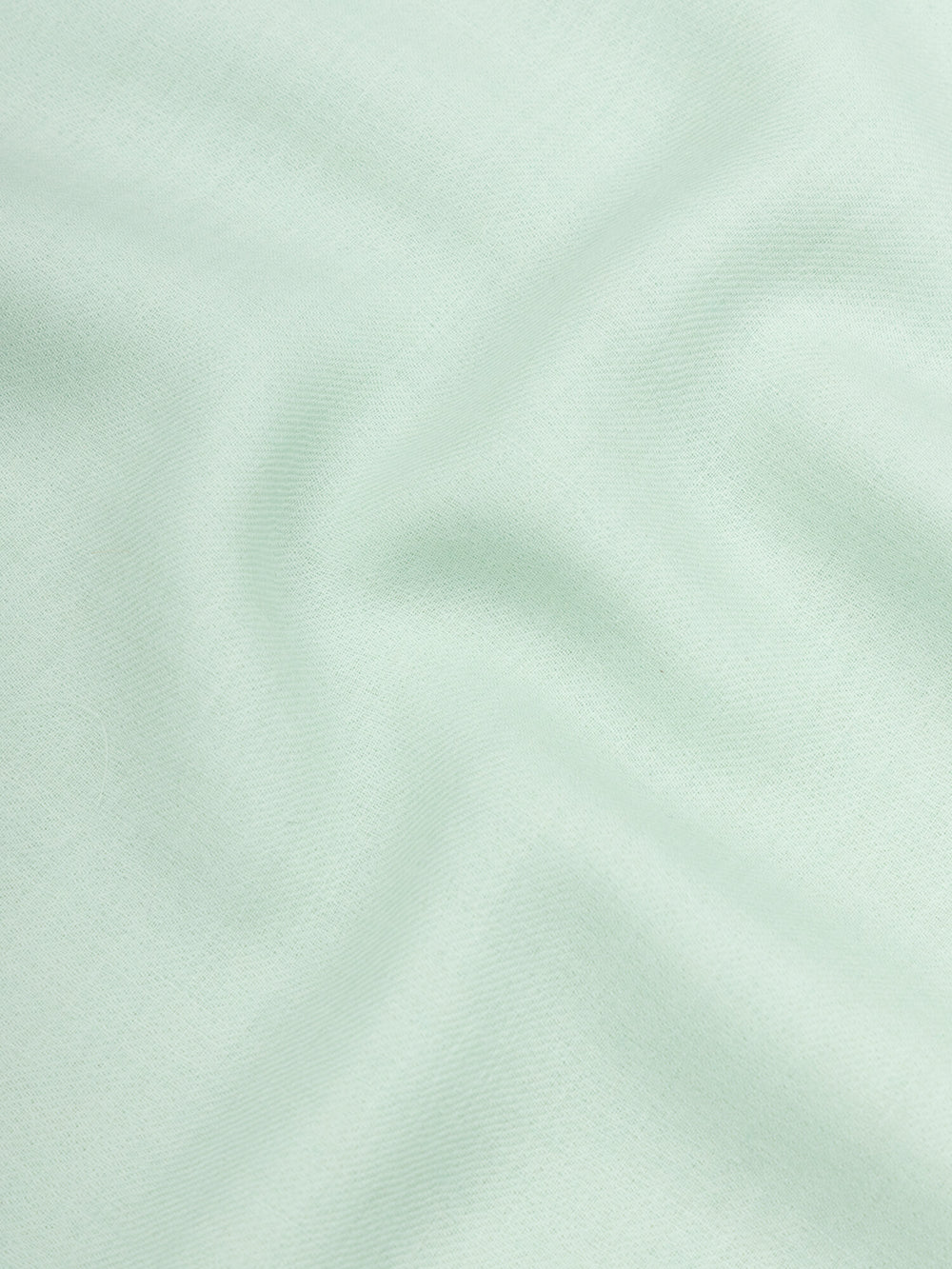 close up of a lightweight mint green cashmere scarf