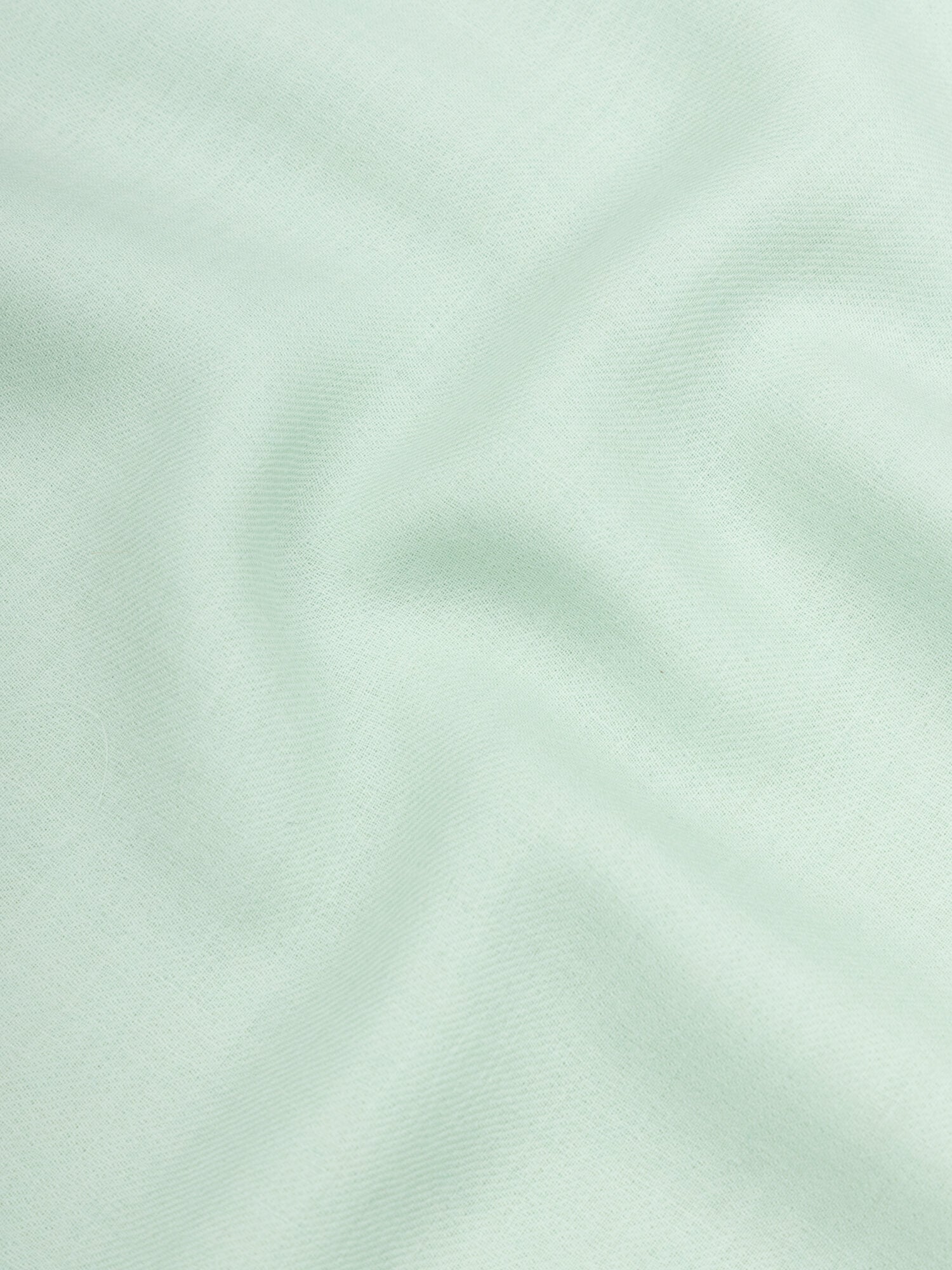 close up of a lightweight mint green cashmere scarf