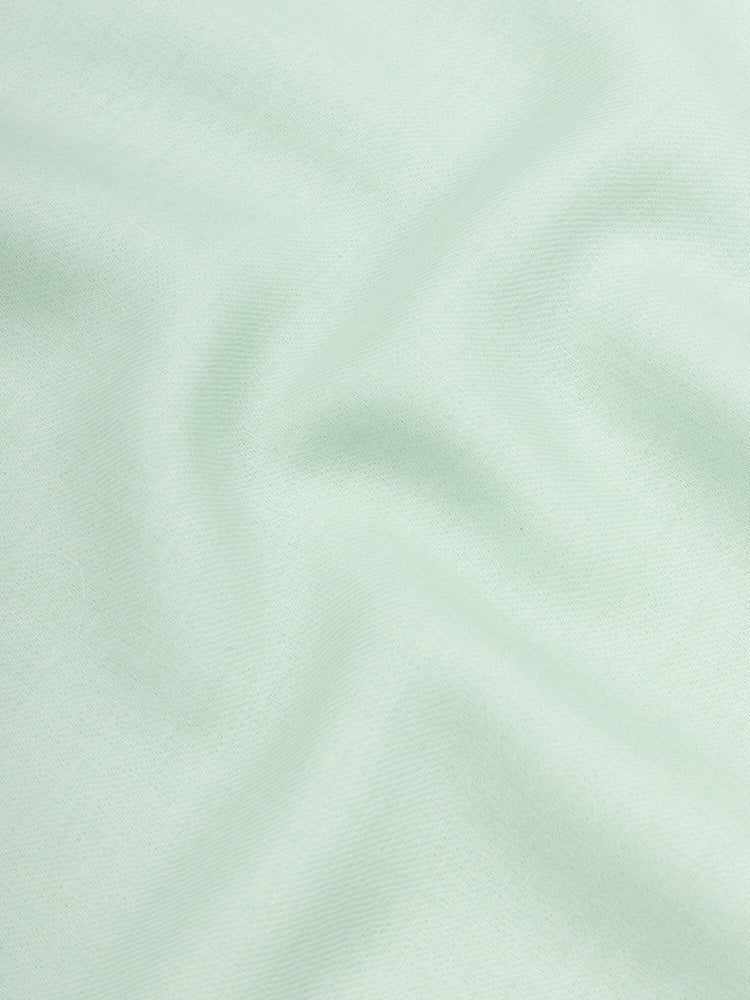 close up of a lightweight mint green cashmere scarf