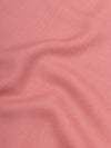 close up of a pink square cashmere scarf on a grey background