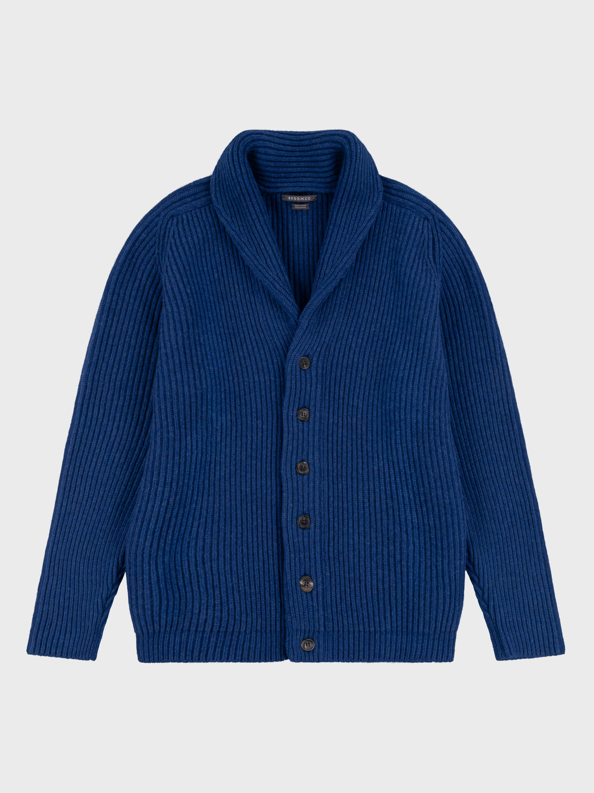 chunky ribbed blue cashmere shawl collar cardigan on a grey background