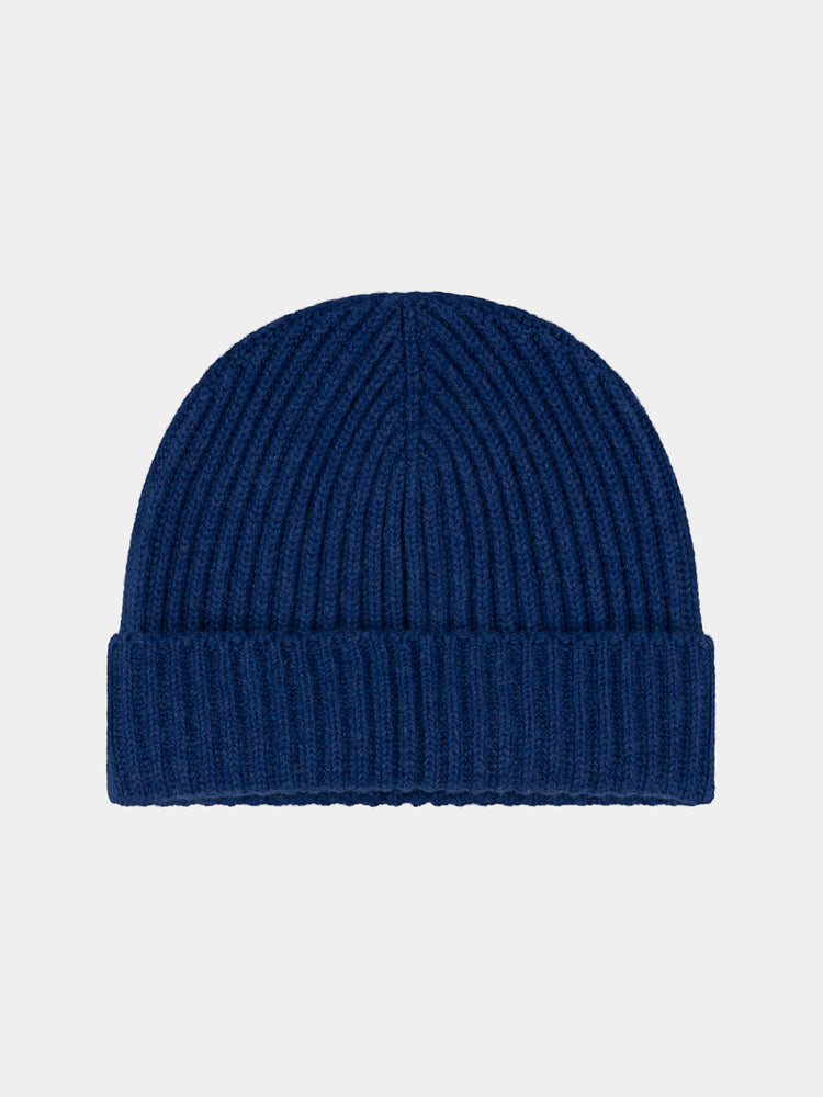 Blue knit cashmere beanie on a light gray background