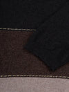 Color-blocked cashmere t-shirt with black, brown, and beige sections on a light gray background