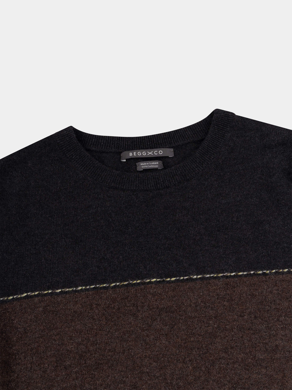 Color-blocked cashmere t-shirt with black, brown, and beige sections on a light gray background