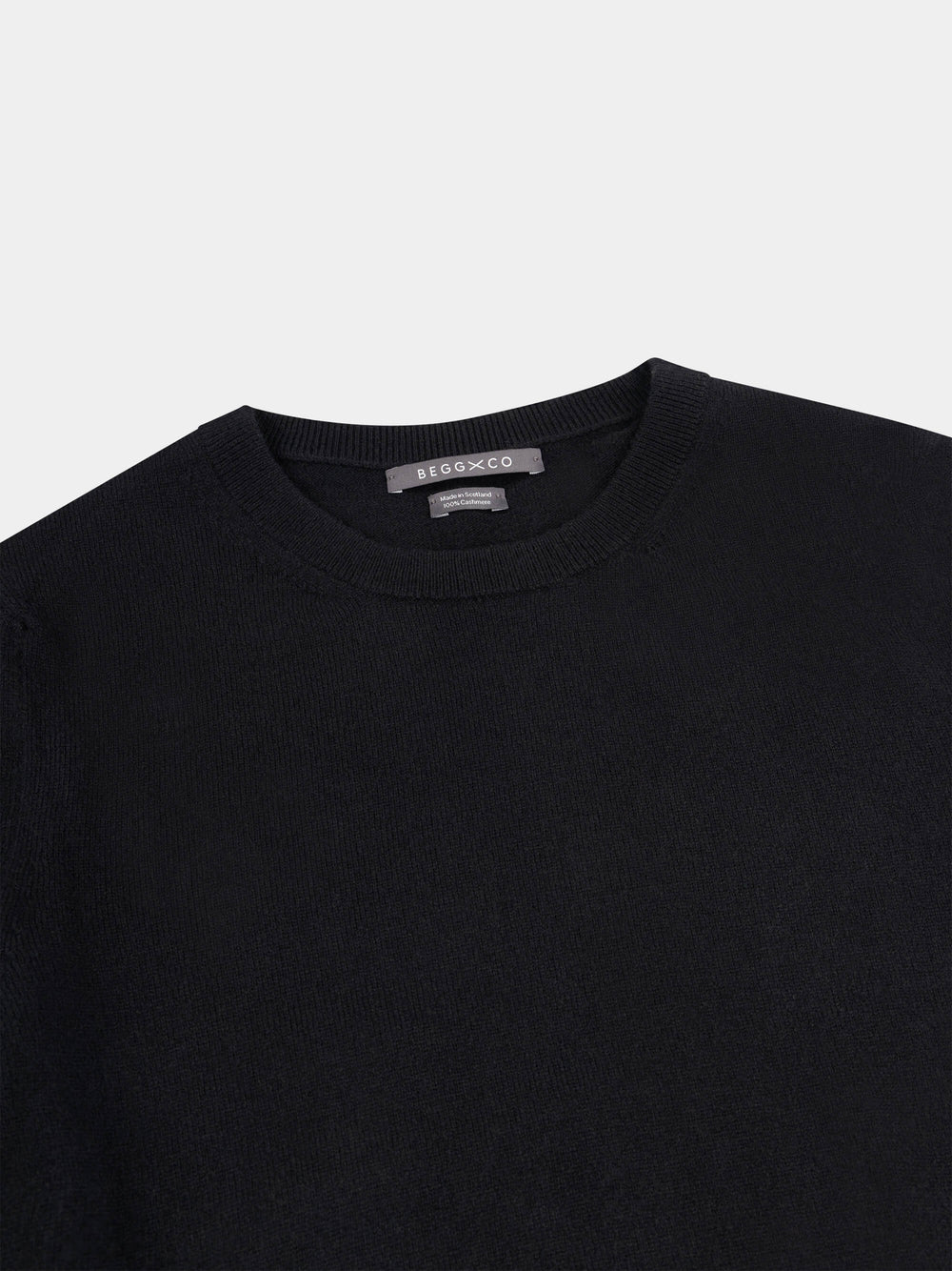 Black short-sleeve cashmere t-shirt on a light gray background