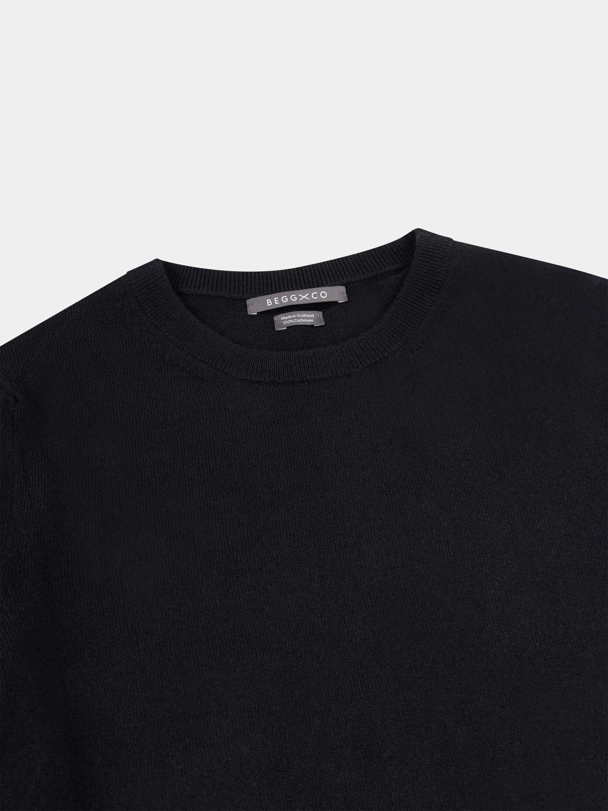 Black short-sleeve cashmere t-shirt on a light gray background