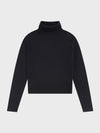 Black turtleneck sweater on a light gray background
