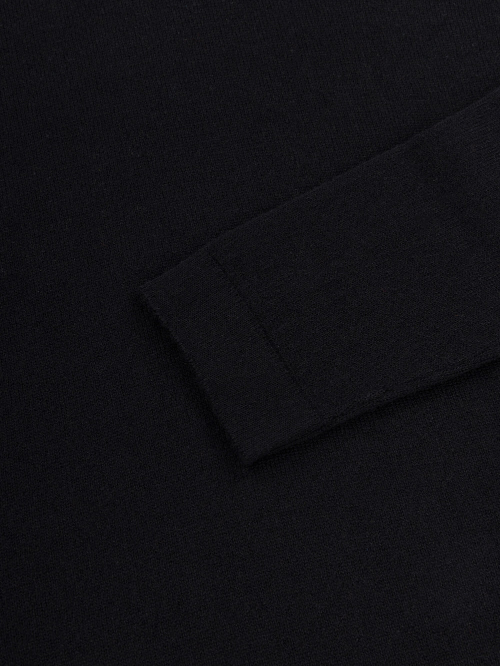 sleeve detail of black lightweight cashmere roll neck sweater