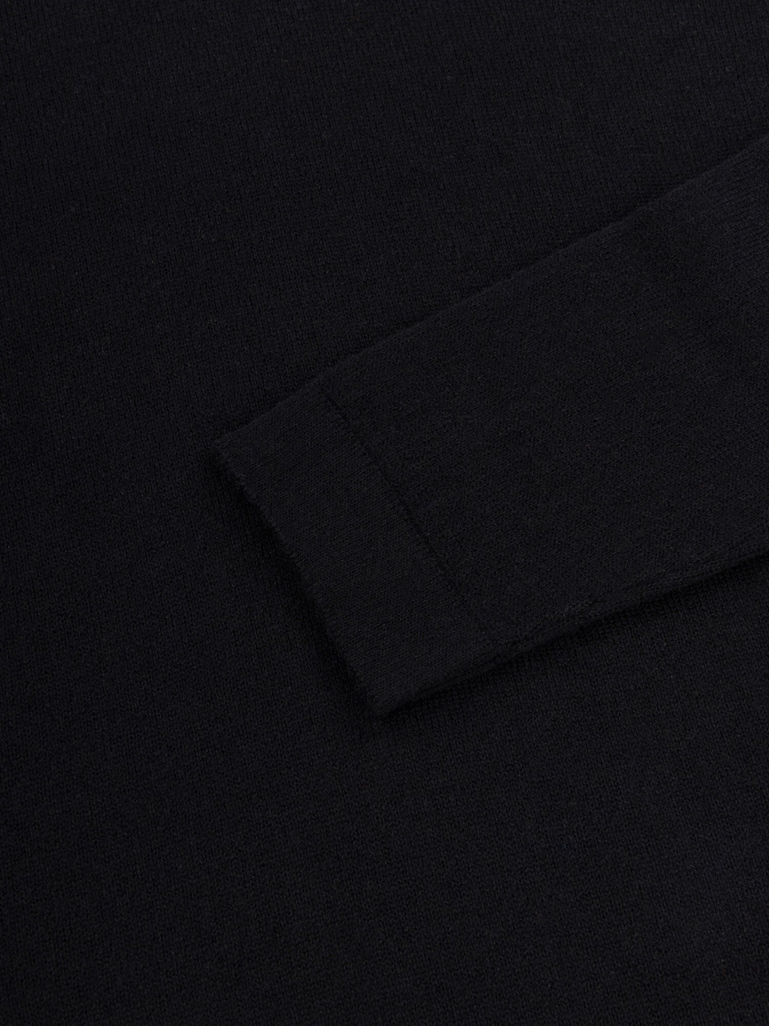 sleeve detail of black lightweight cashmere roll neck sweater