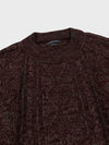 Brown and red knitted sweater on a light gray background
