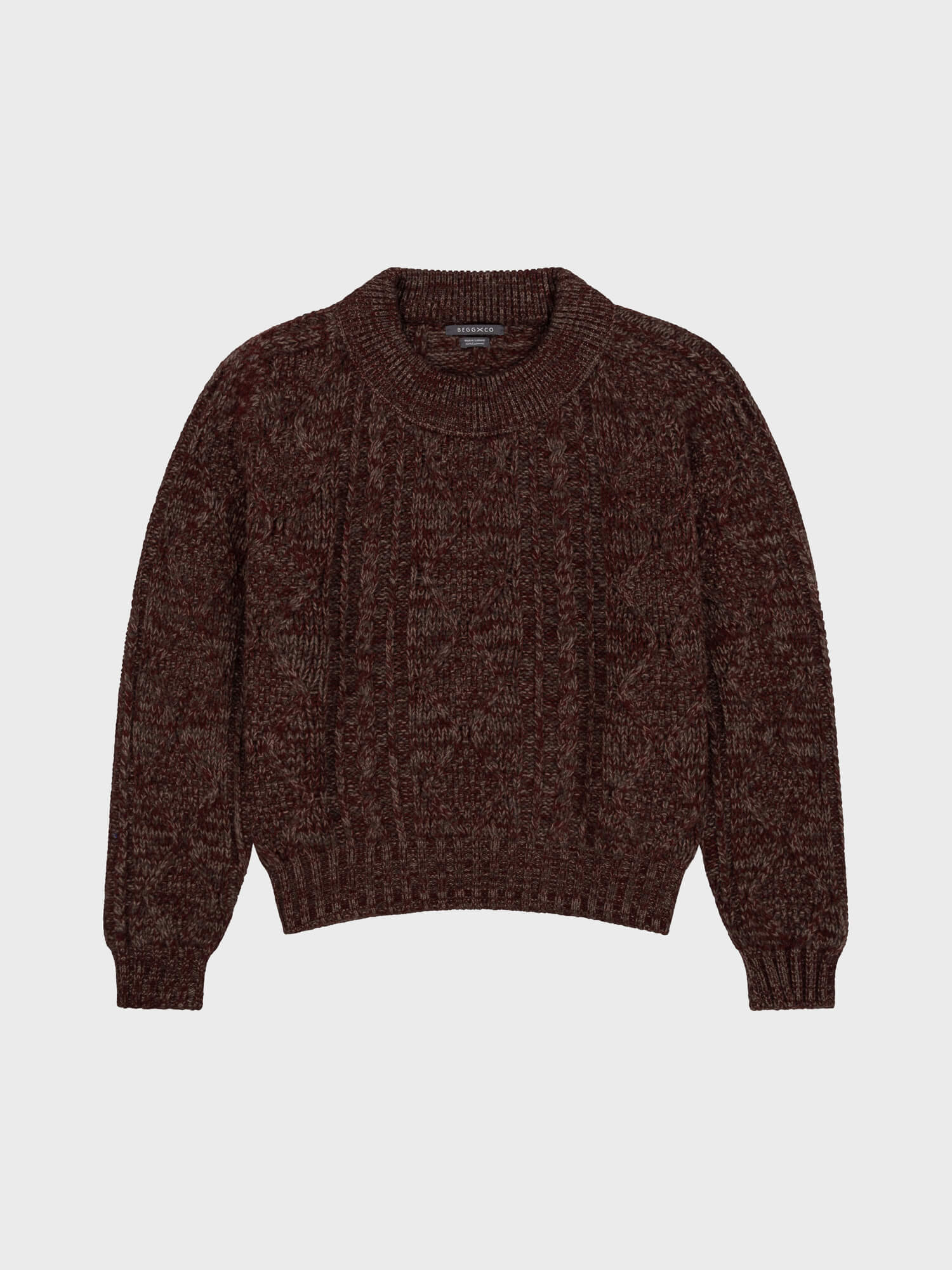 Brown and red knitted sweater on a light gray background