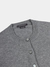 Gray cardigan with button details and Begg x Co label on a light gray background