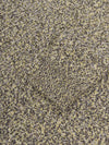Close-up of textured fabric with a pattern of dark and light colors.