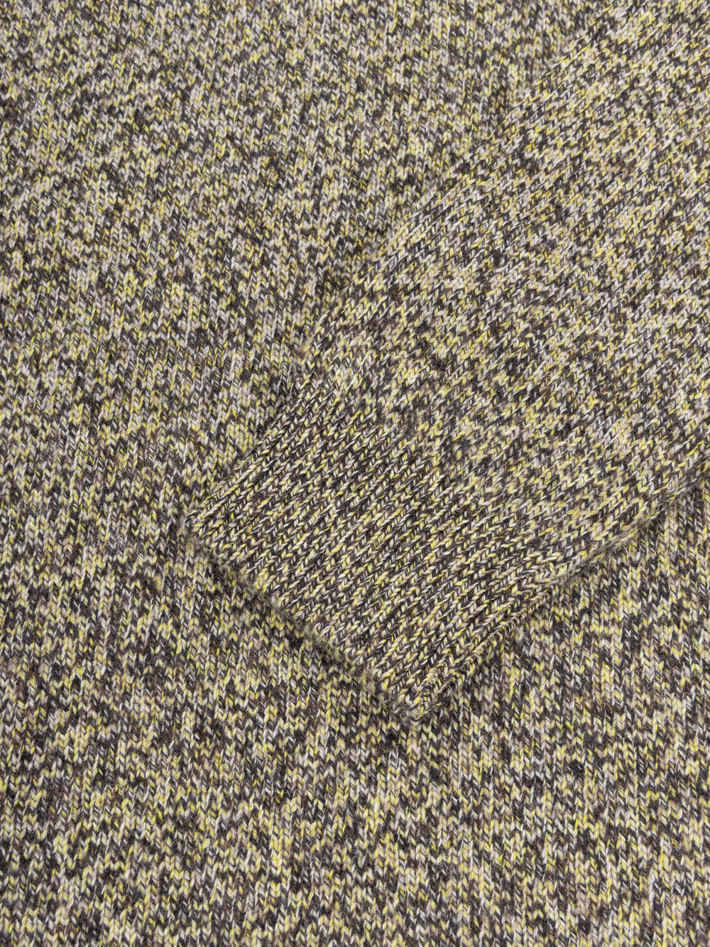 Close-up of textured fabric with a pattern of dark and light colors.