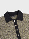 Textured sweater dress with black collar and buttons on a light gray background