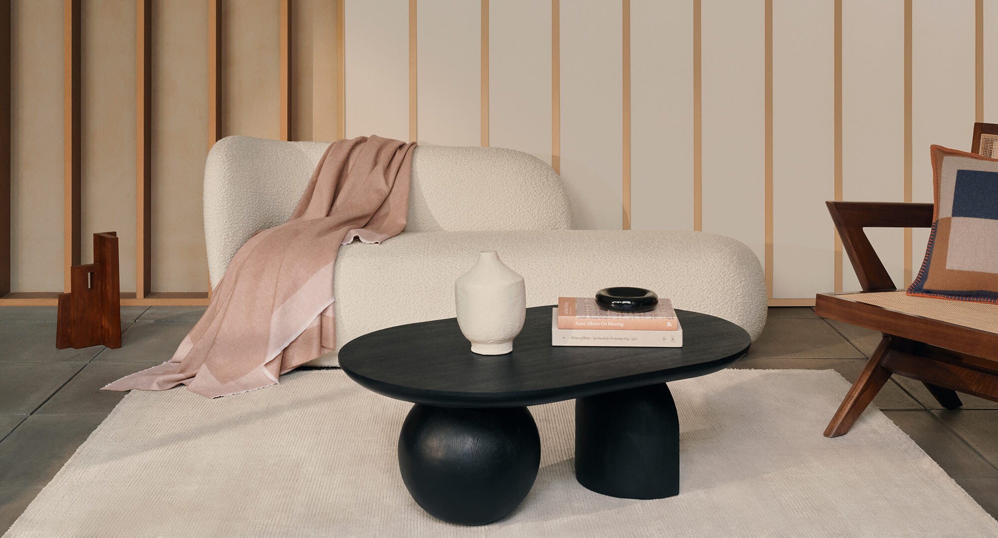 pink cashmere throw on a beige boucle sofa