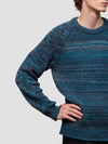 man wearing a blue cashmere knitted sweater on a plain background