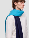 man wearing a blue and navy scarf on a plain background