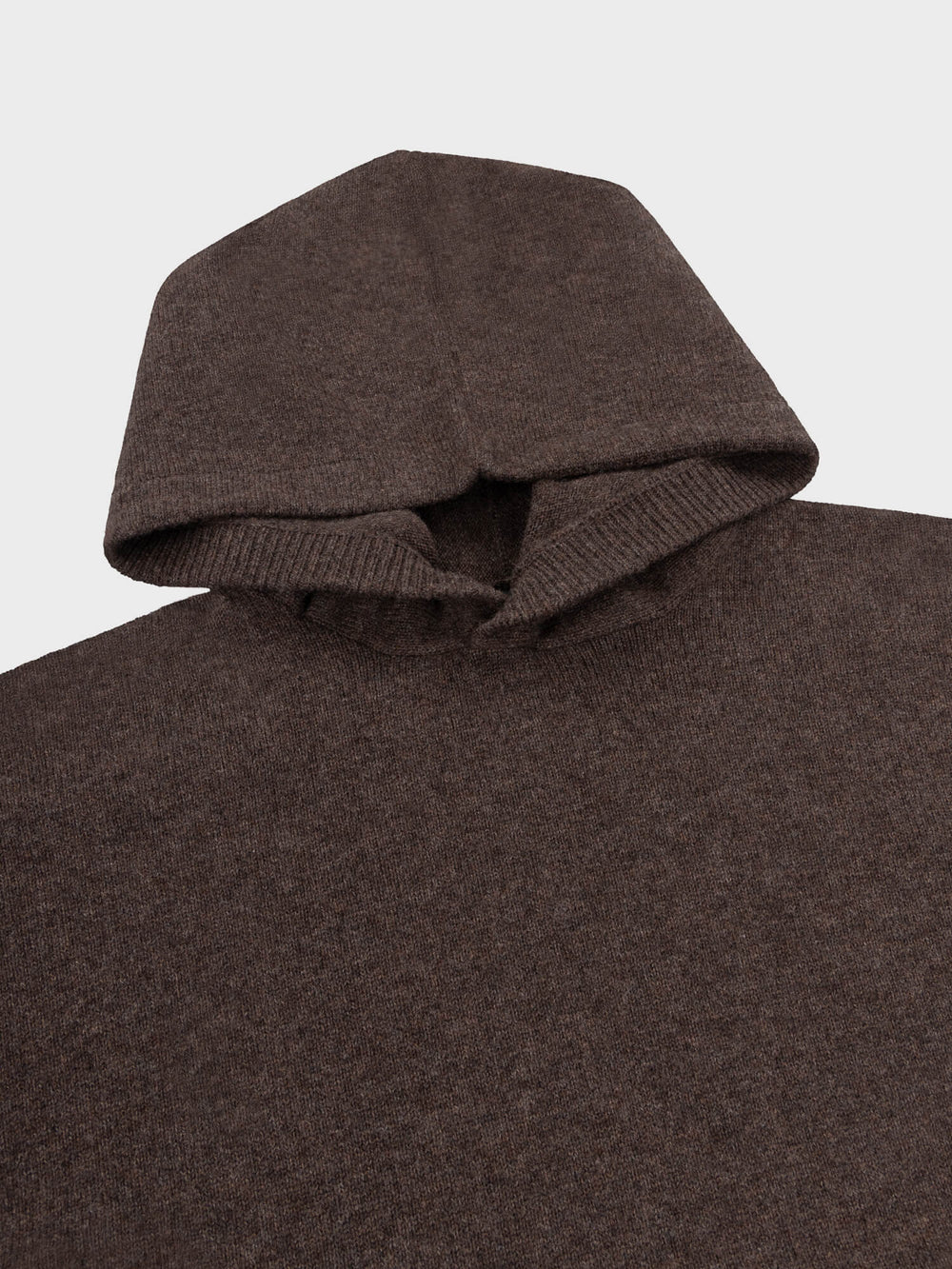 Brown knitted sweater with a hood on a light gray background