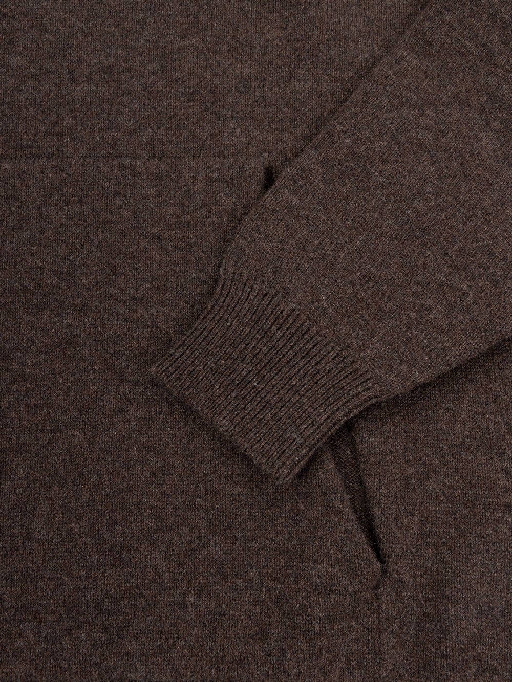 Close-up of a brown cashmere hoodie with a focus on the neckline and sleeve.