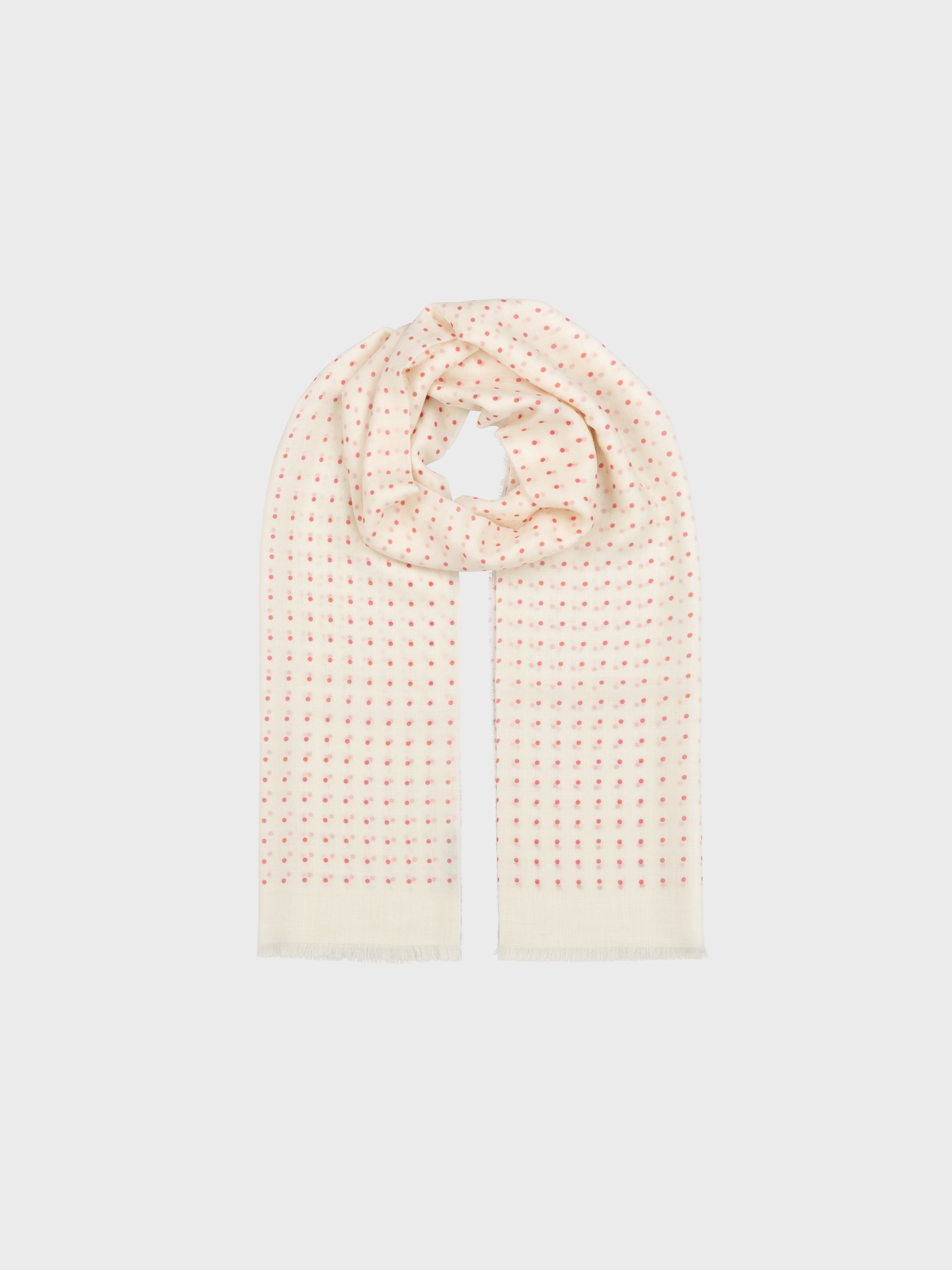 Pink and white polkadot scarf on a light gray background