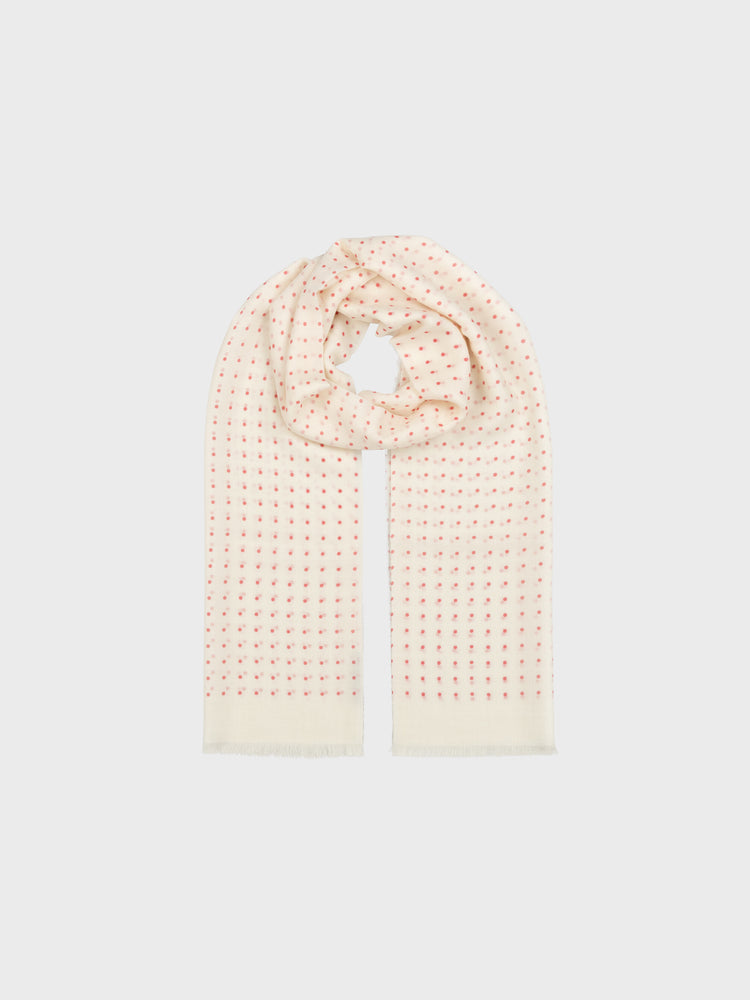 Pink and white polkadot scarf on a light gray background