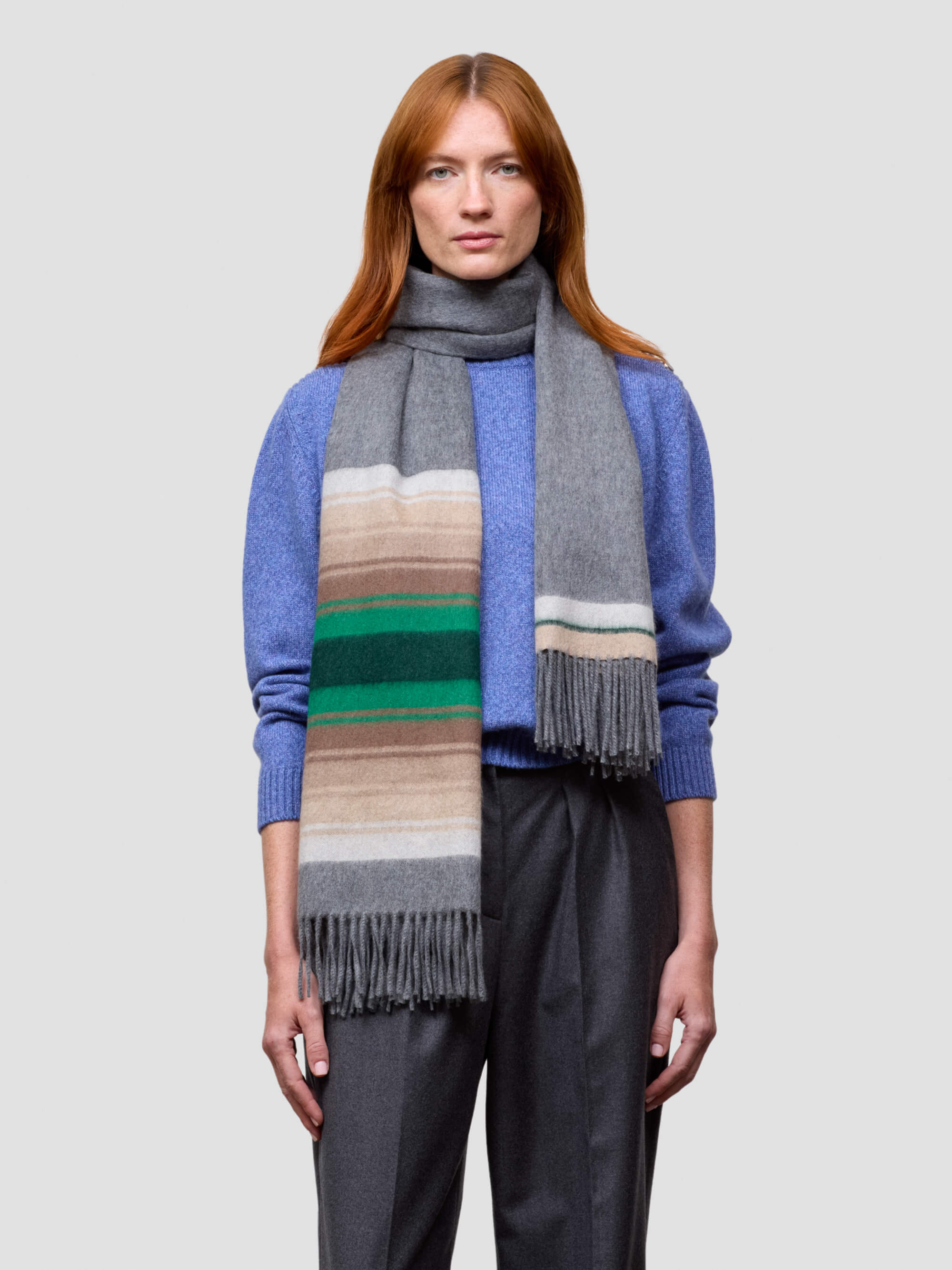 Person wearing a colorful scarf with a gray background