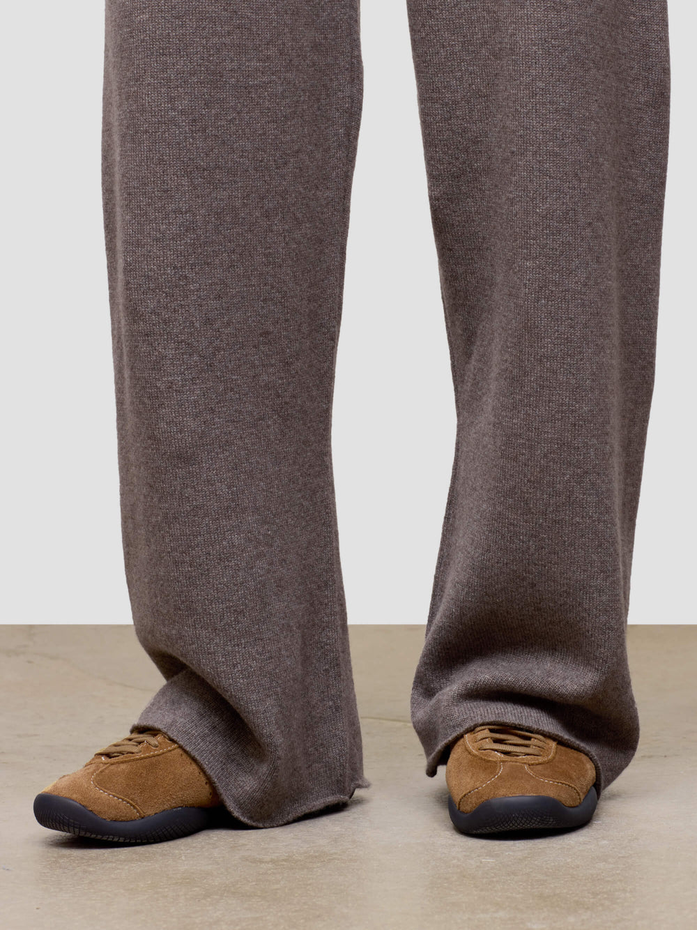 Brown pants and brown shoes on a plain background